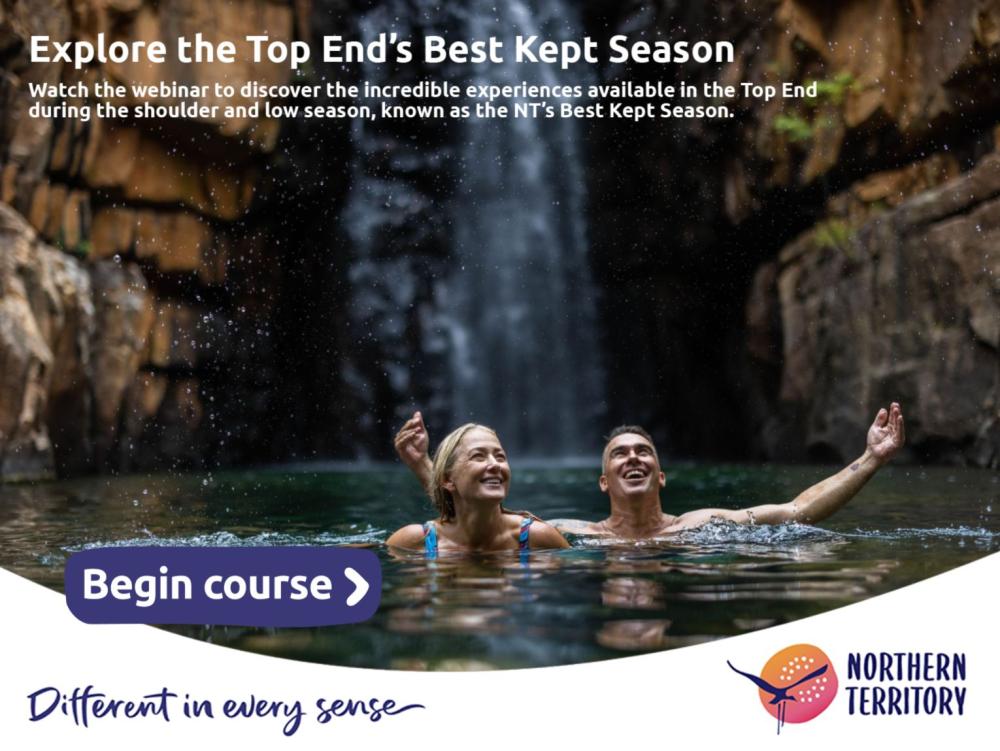 couple swimming under a waterfall