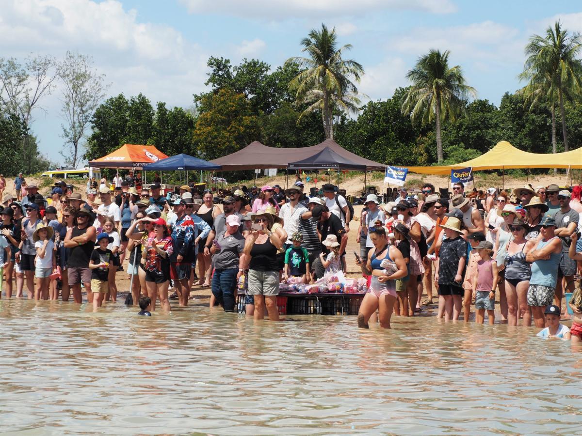 People rowing in a raft made of beer cans