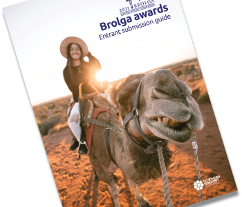 Picture of girl riding camel with a 2021 Brolga awards logo in top right