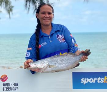 Million Dollar Fish winner holding up $10,000 barra