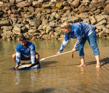 Sportsbet's Thijs Bors and Minister for Major Events Marie-Clare Boothby release a red-tagged barra